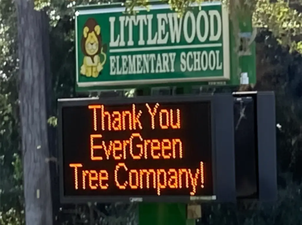 Digital sign at Littlewood Elementary School displaying the message: "Thank You EverGreen Tree Company!", highlighting community appreciation for local service.