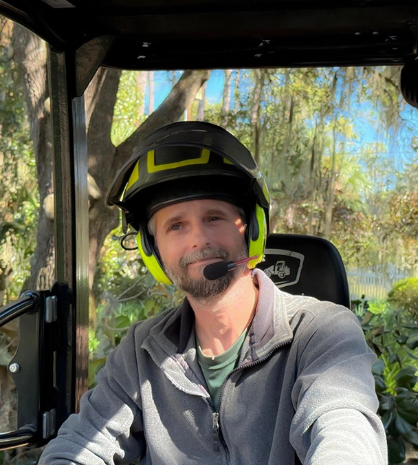 Tree care professional operating heavy equipment for safe tree removal **Caption** Evergreen Tree Company crew performing professional tree removal with precision and care. **Description** An experienced Evergreen Tree Company team member operating specialized equipment during a tree removal job. Our crews are trained to handle trimming, removals, stump grinding, and hazardous trees safely and efficiently, always prioritizing customer satisfaction and job site safety.